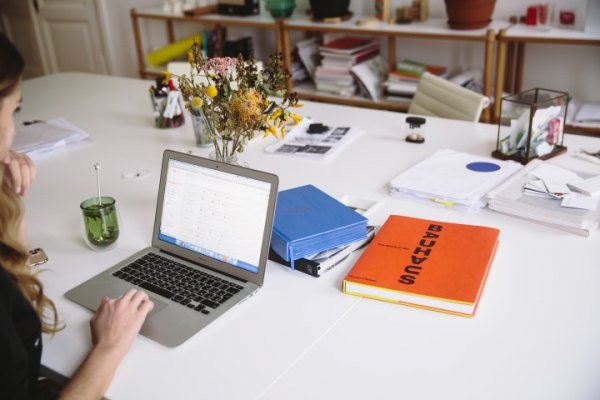 Person at desk with computer open